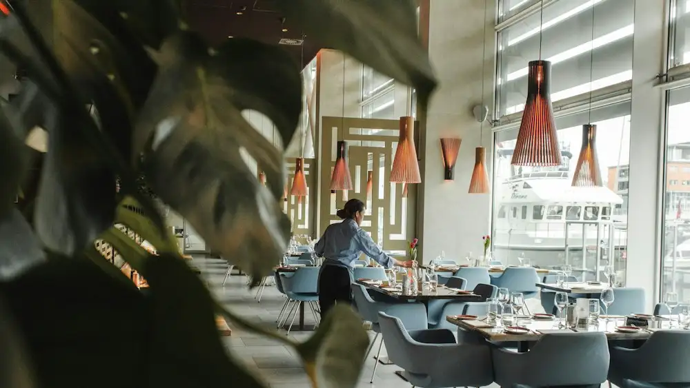 Hotel Jobs in Dubai: 10 Best Roles & Easy Steps to Apply in 2026 Restaurant waiter serving guests – hospitality jobs in Dubai
