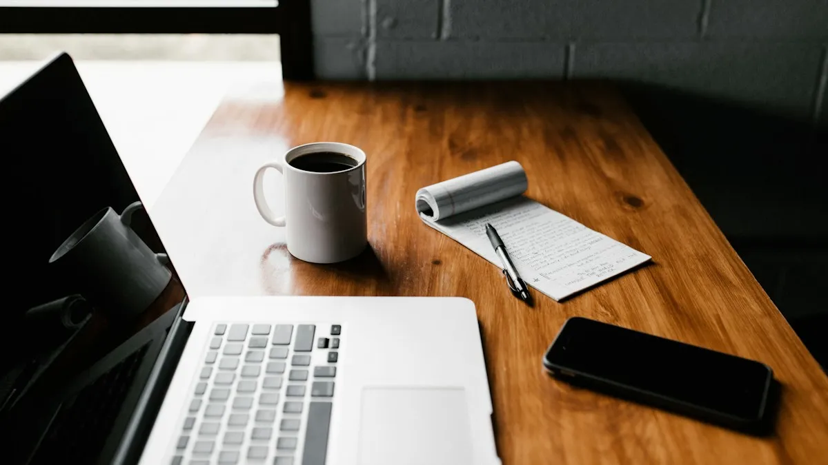 CV format – laptop and notebook on a desk for writing a Gulf CV