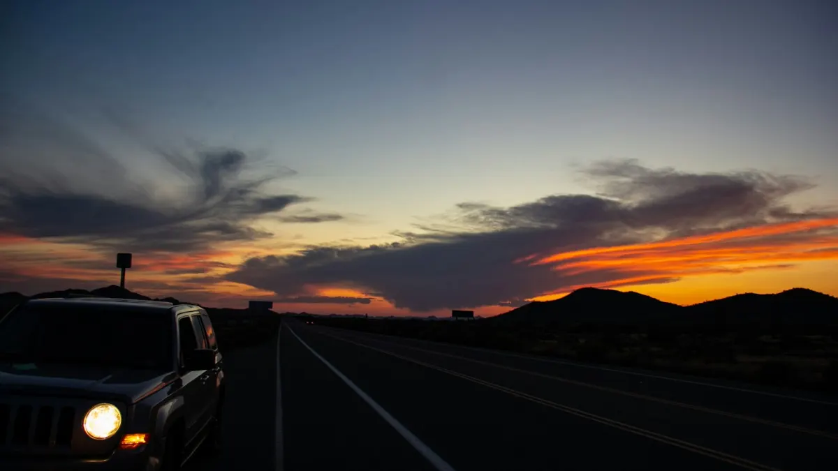 Heavy Driver Jobs in UAE 2026: Licence, Salary, Visa & How to Apply Truck driving through the desert at sunset